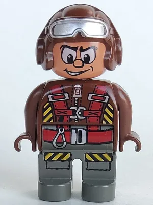 Duplo-figuur, mannelijk actievoertuig, donkergrijze benen, bruin bovenstuk met parachutebanden, bruine helm met bril.